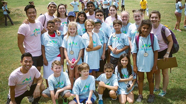 Kathlyn poses with her fellow counselors and her 16 campers at Camp Kesem.