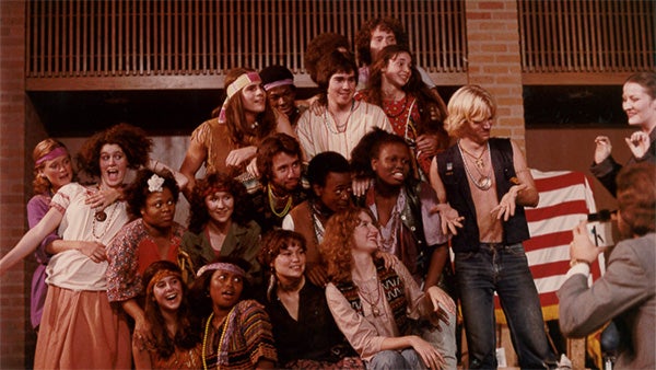 A picture of a large group of students performing in a play on stage.