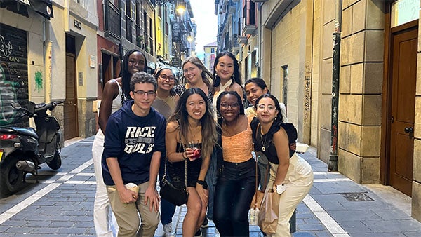 Linda poses with her fellow Rice students in a street in Pamplona.