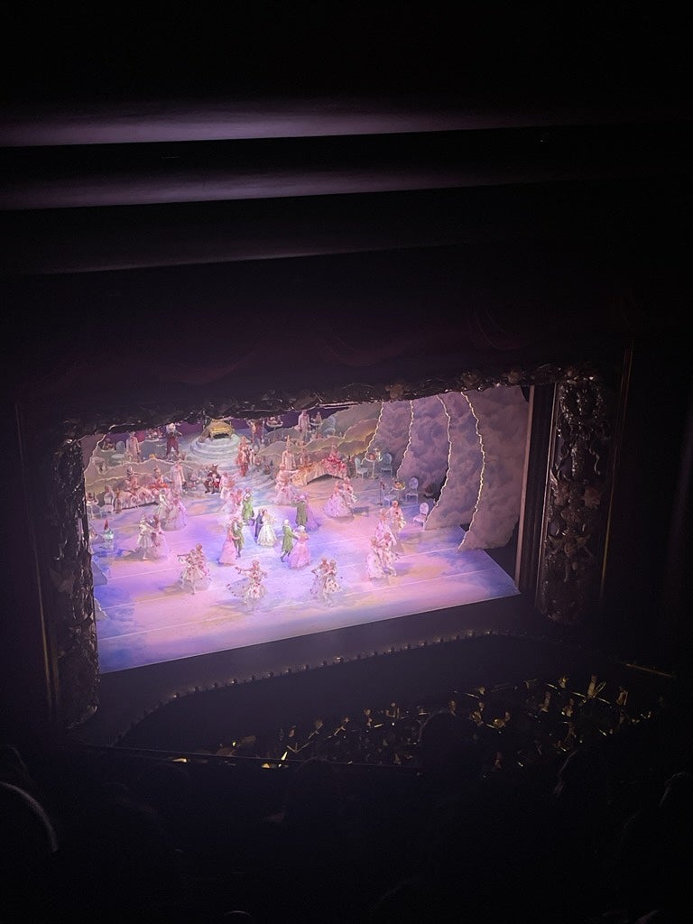 A faraway shot of the stage with dancers in costumes performing.
