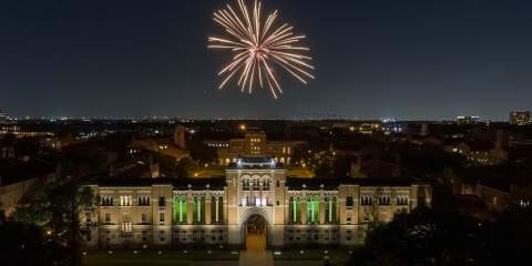 A drone picture taken from above Lovett Hall at night with a firework above from matriculation in 2022.