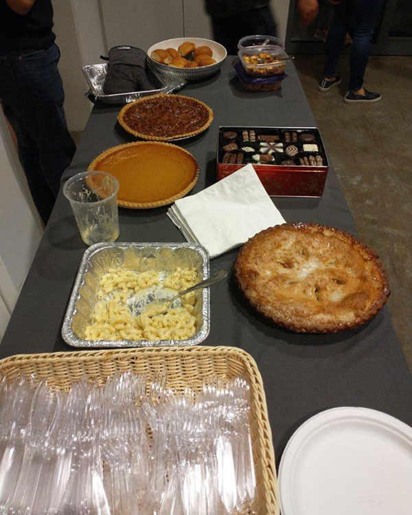 A picture of Thanksgiving food spread out on a table such as pumpkin pie.