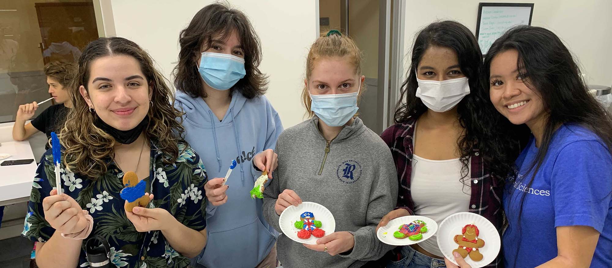 A group of students shows off their cookie decorations at the Martel study break.