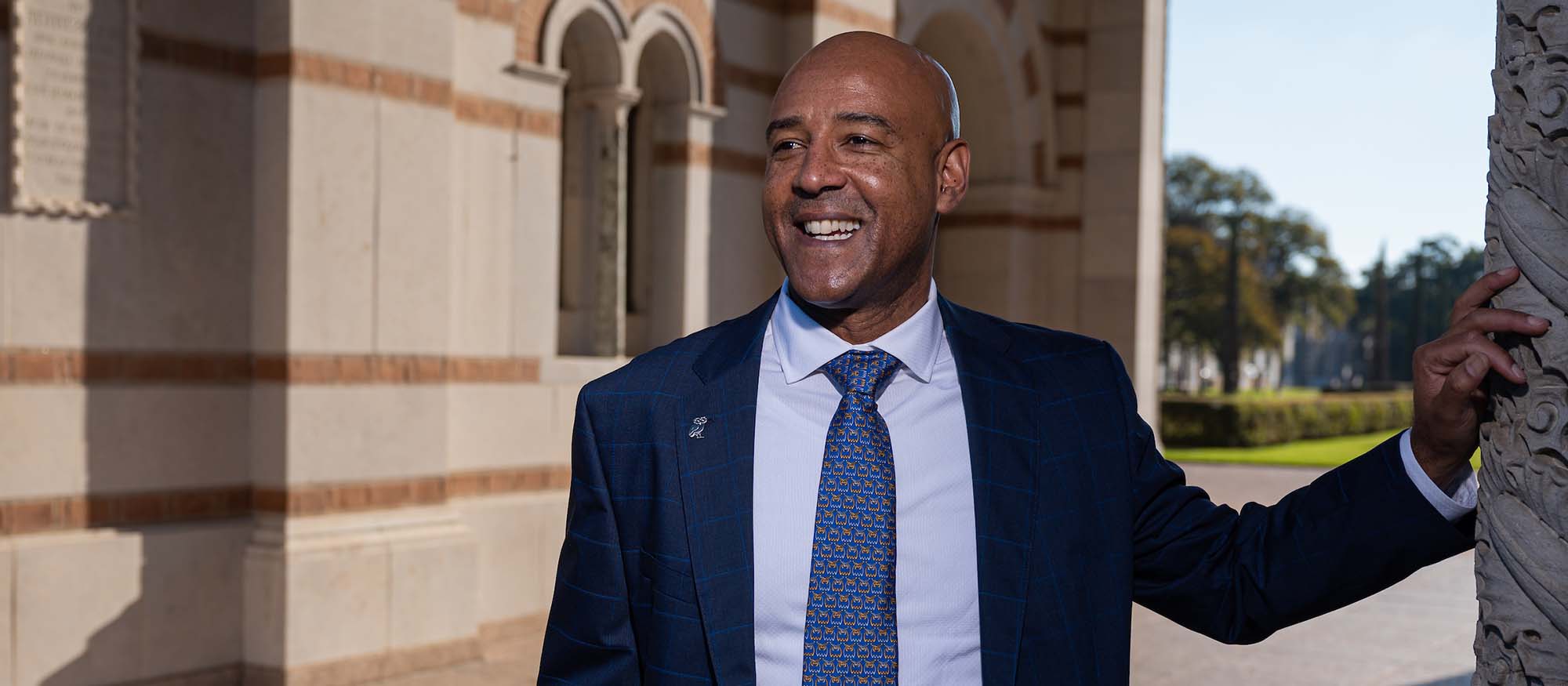 Headshot of Provost Reginald DesRoches, smiling as he stands under the Sally Port of Lovett Hall.