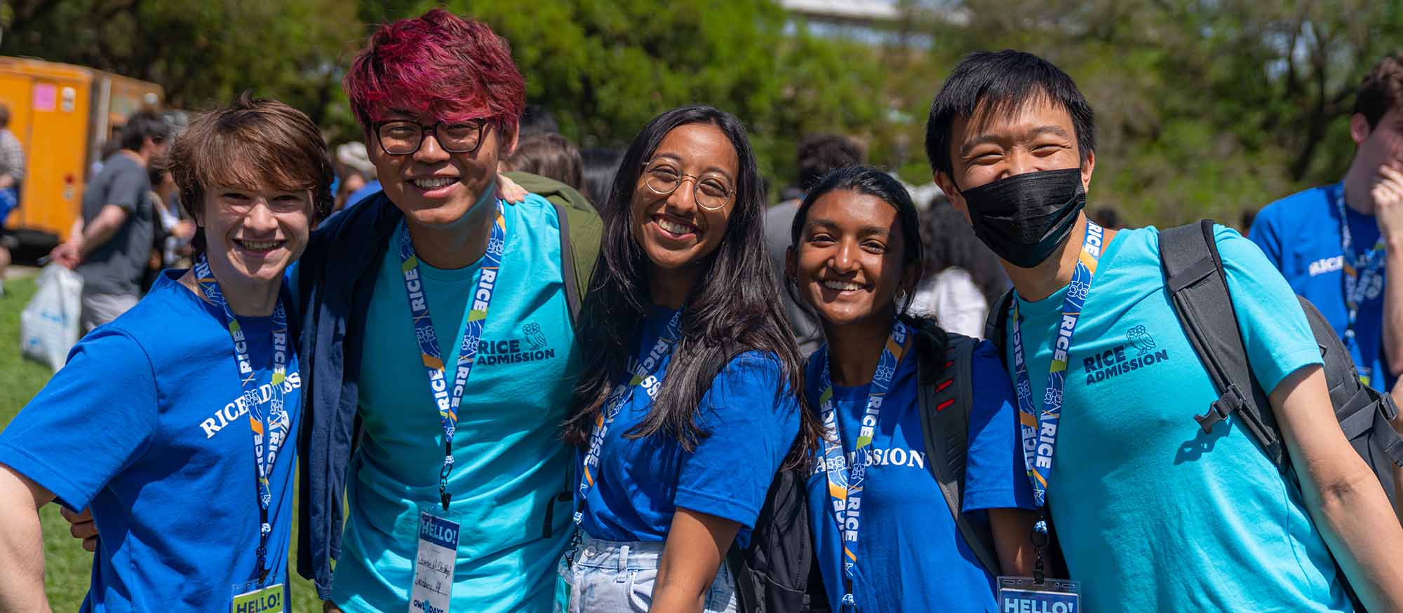 A group of male and female Rice students pose smiling for a picture at Owl Days 2022.