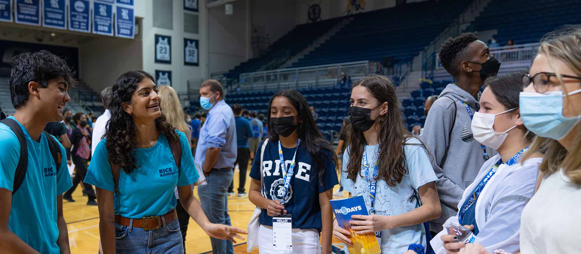 A picture of the two Marketing and Communication Interns, Naman and Devika, talking to admitted students at the Major Mixer on the second Owl Day.