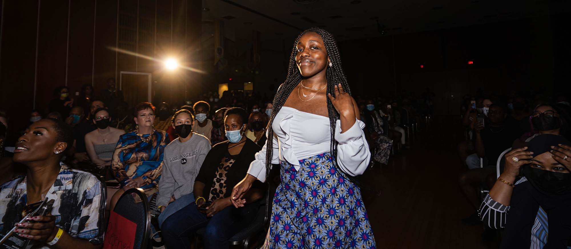 A Black student poses for a picture during the fashion show from Africayé 2022.