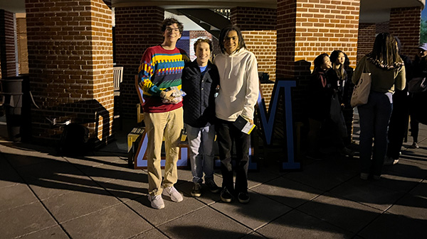 Three male students at Martel College smile for a picture.