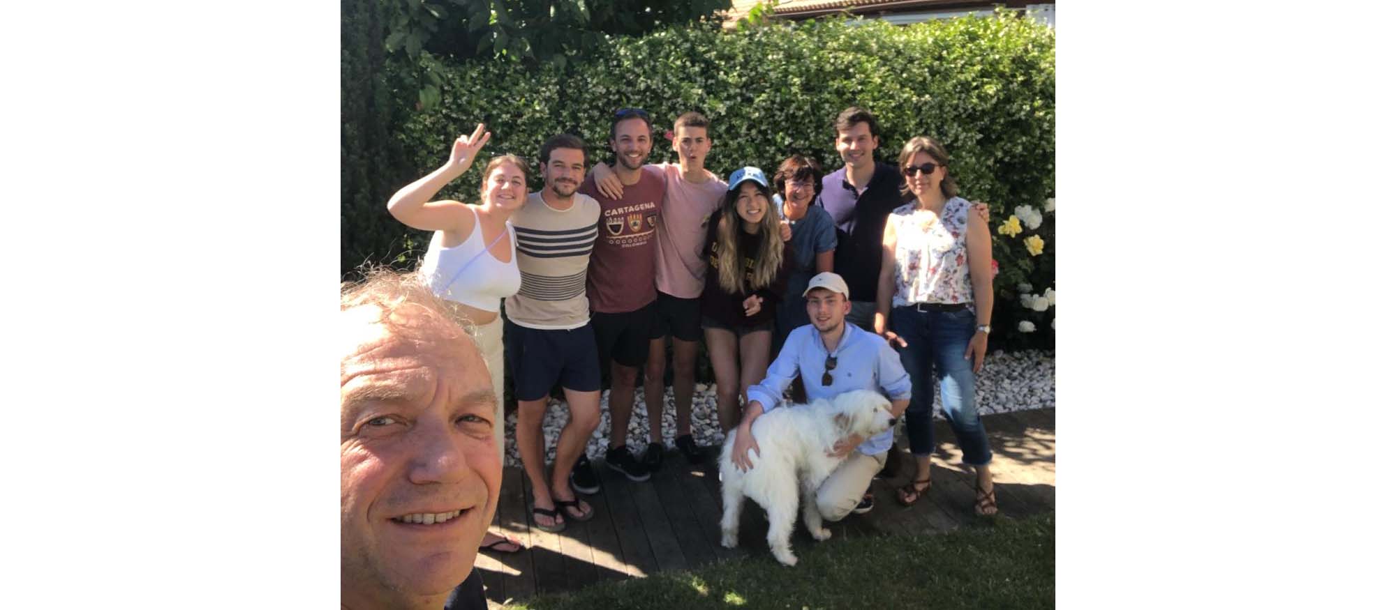 Linda poses for a picture with her host family as well as their white, fluffy dog.