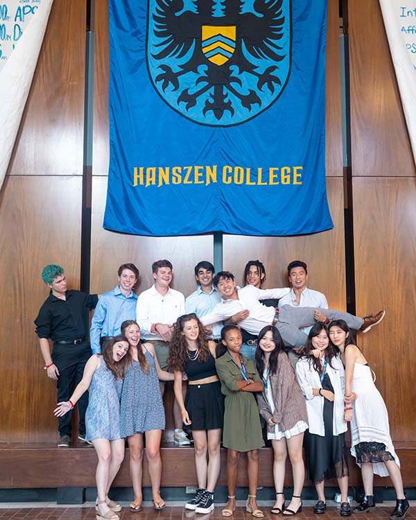 The Advisors for Hanszen College pose for a picture in front of their banner.