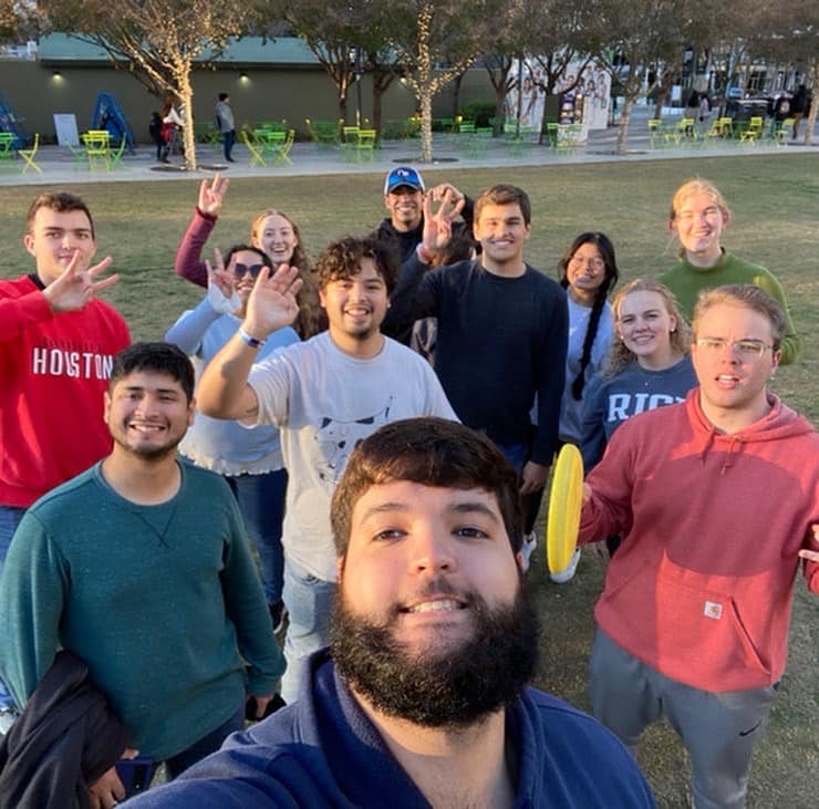 A selfie with students smiling and waving to the camera.
