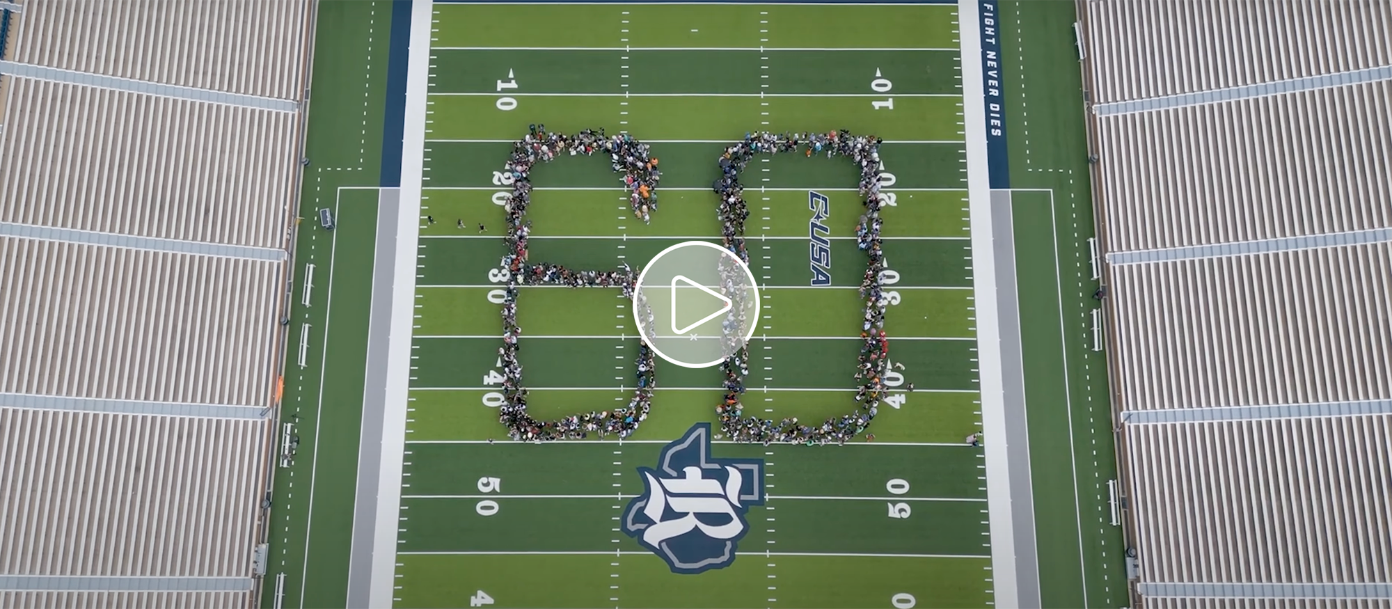 Aerial view of Rice University football field with people standing on the field to form the number 60.