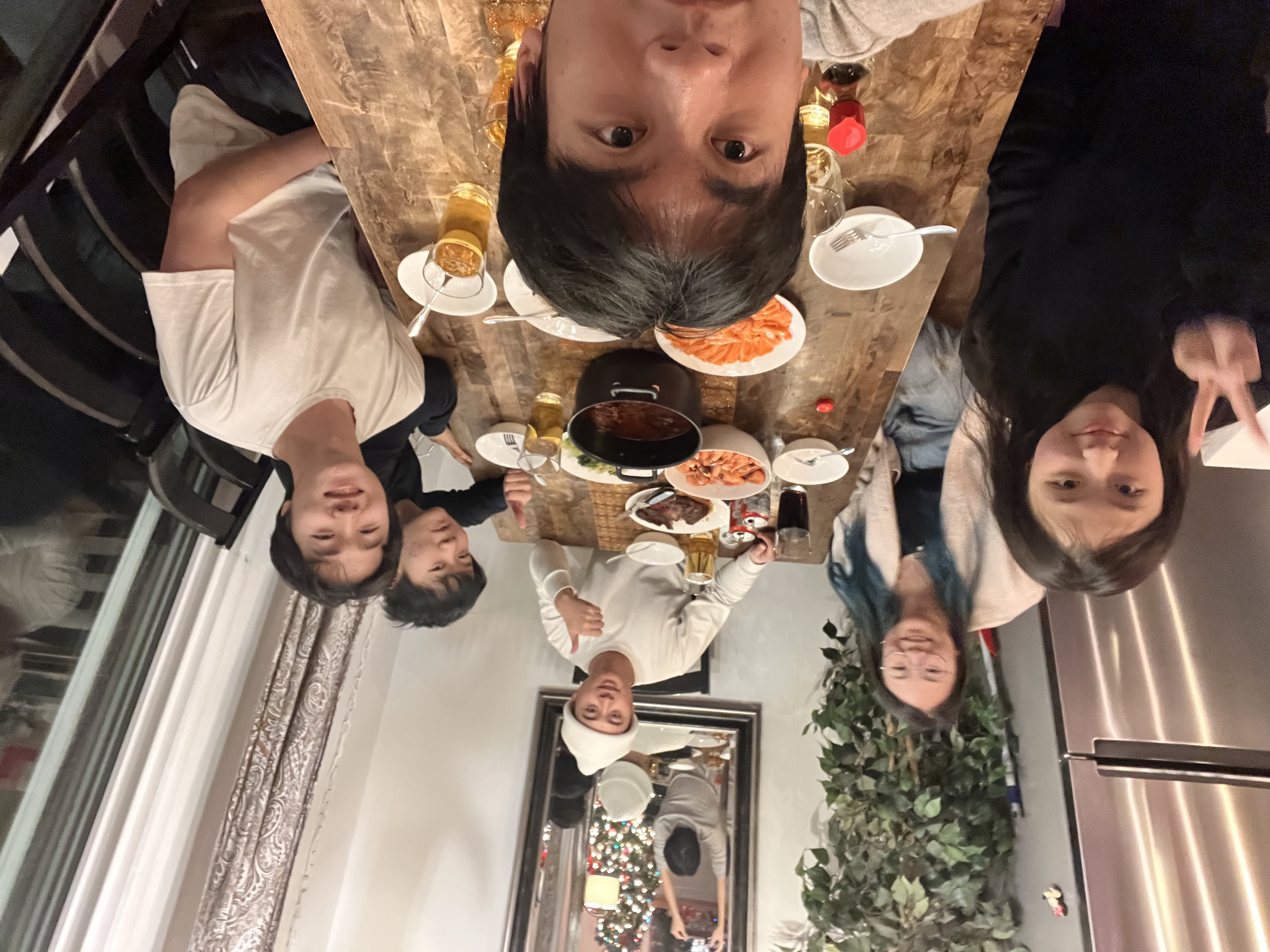 Selfie taken with 6 students in frame at a dining table with food set up.