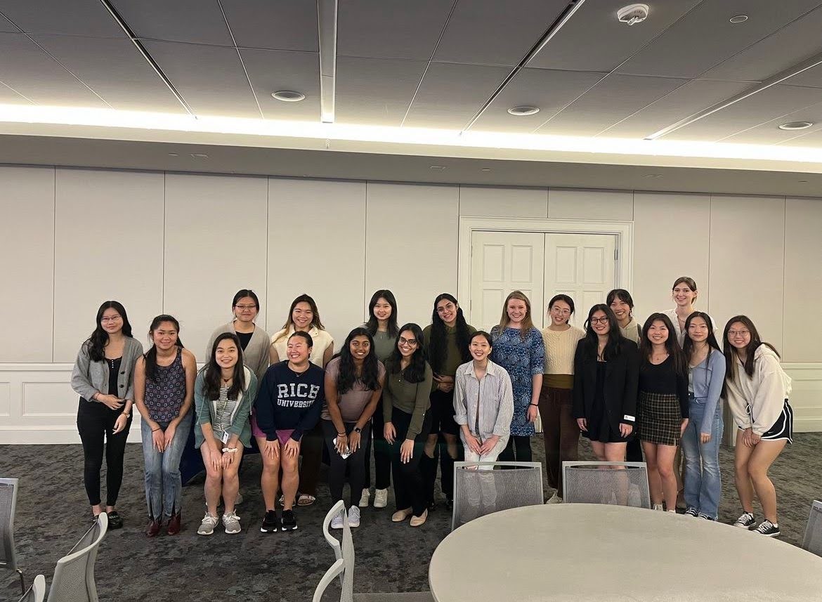 Two rows of female students in a classroom.