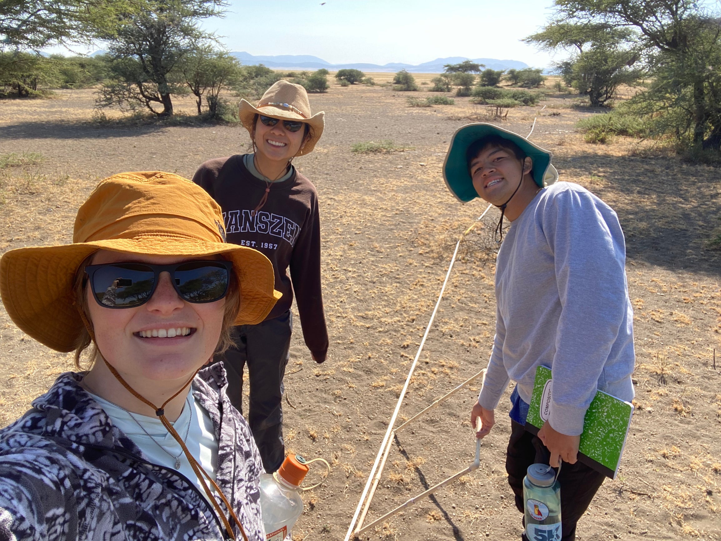 3 college students posing for a selfie in the Savannah wearing hats and sunglasses 