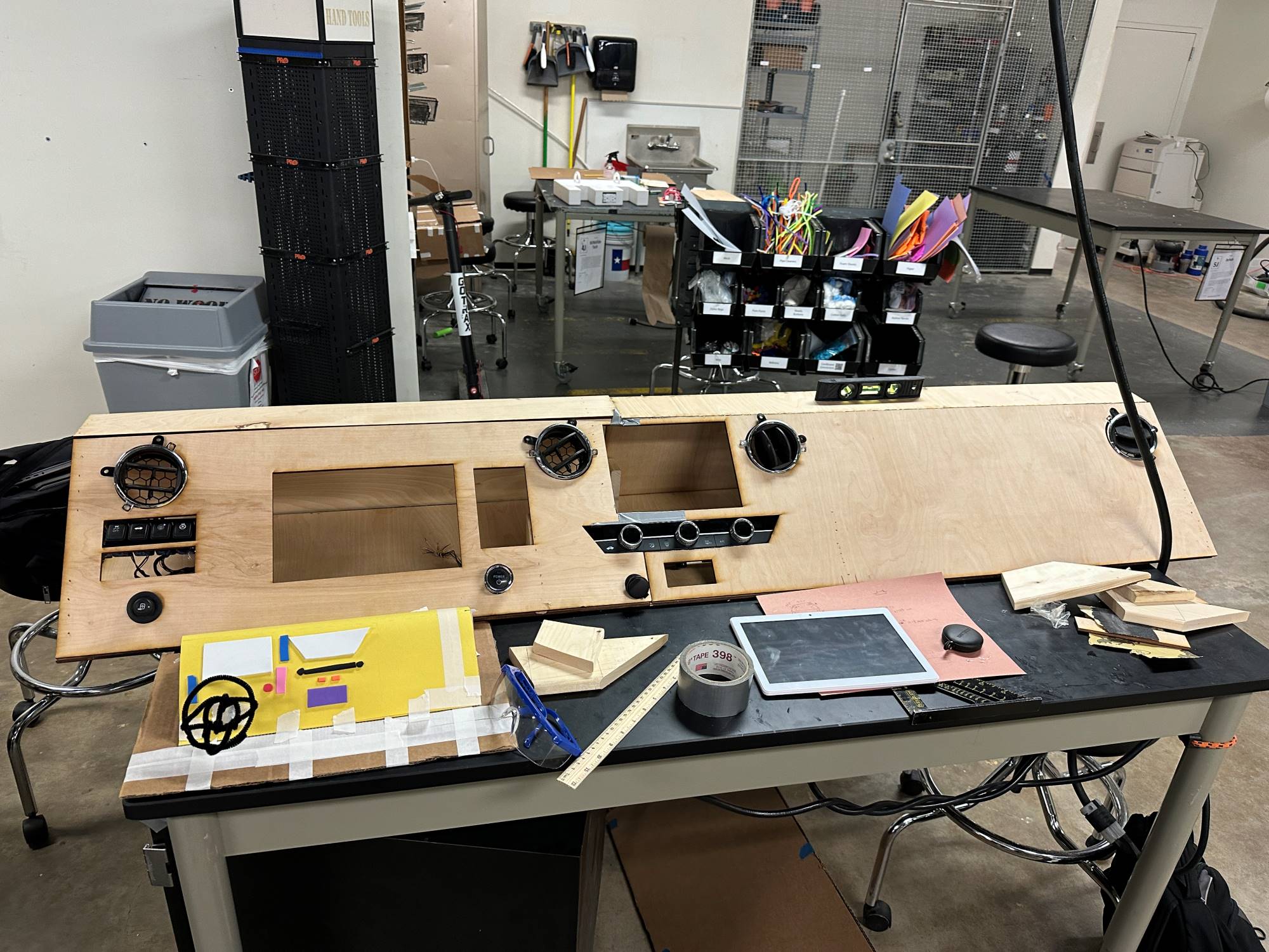 The wooden panel that makes up a car dashboard placed on a table