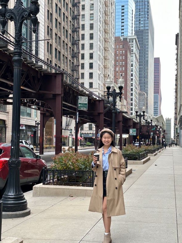 A vertical photo of a girl posing in the streets of Chicago 