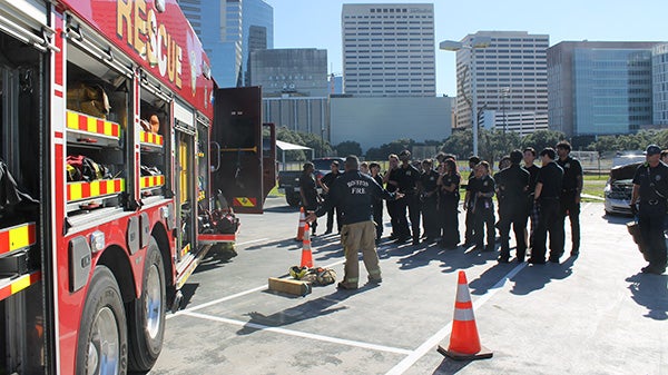 A group of trainee EMT's in front of a firetruck