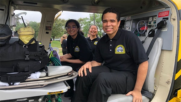 A female college student sitting in a helicopter