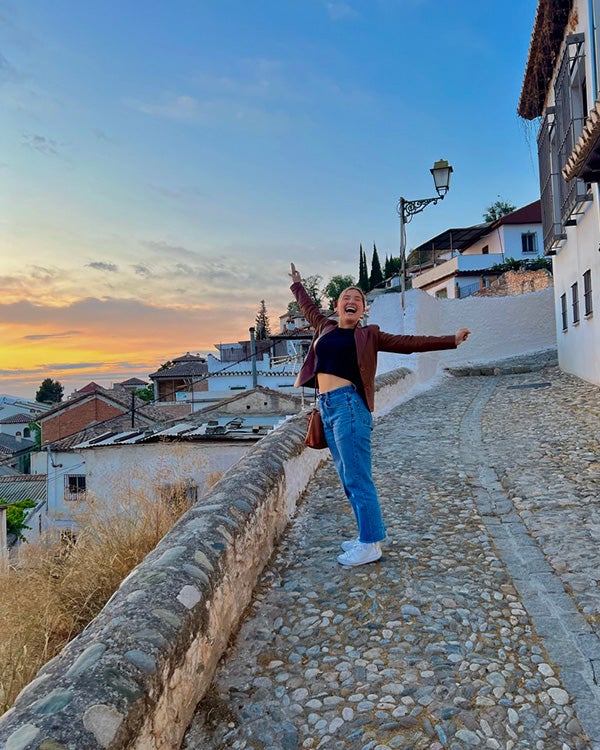 A girl posing for a photo on stairs 