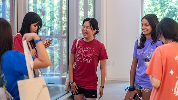 Students chatting at an admission event.