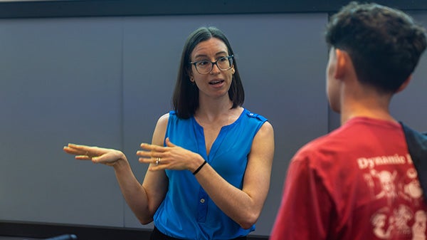 An instructor chatting with a student.