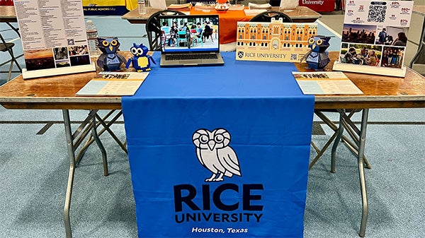 A photo of a Rice University table at a recruitment fair.