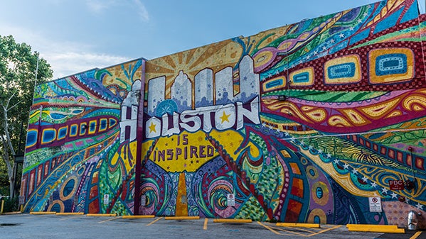 A colorful wall mural sporting the words "Houston is Inspired"