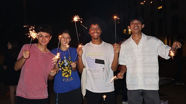 Rice student Chaianan and his friends pose with sparklers.