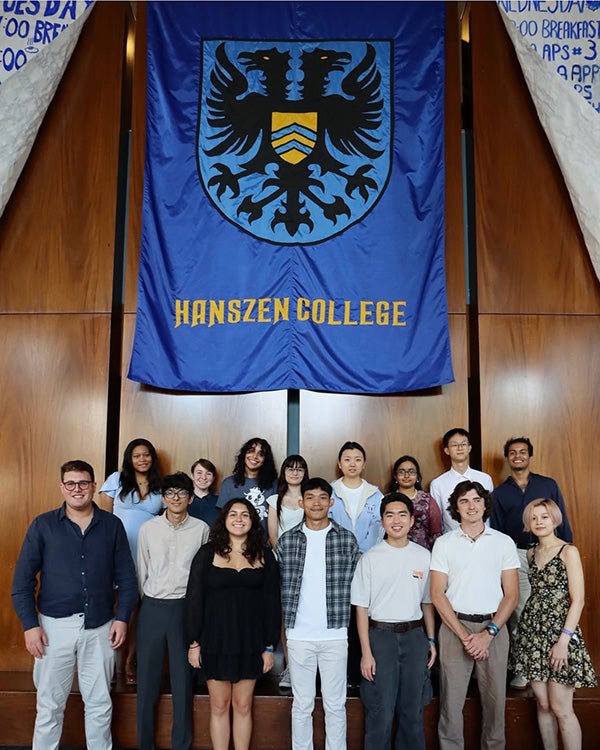 Hanszen residential college students pose under a large college banner.