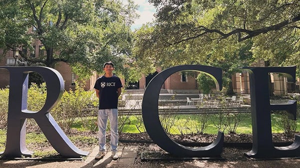 Blog writer Chaianan poses for a photo as the I in life-size letters spelling RICE