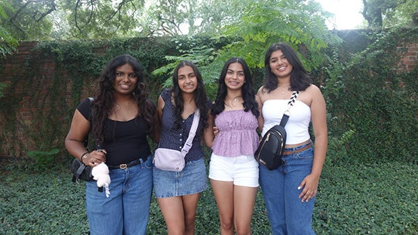 Four girls posing outside
