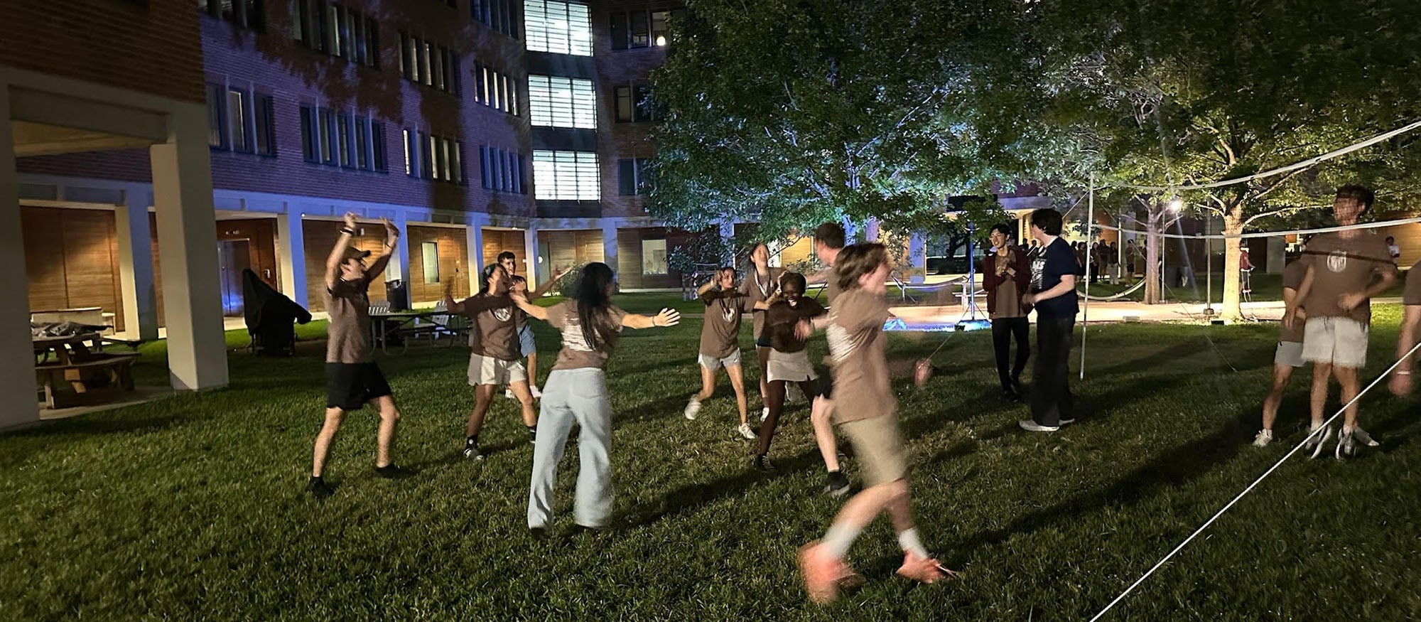 Students running around in outdoor courtyard