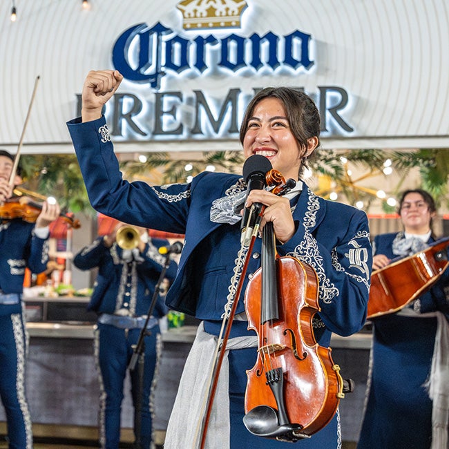Girl holding violin one hand, other arm fist pumped in the air 