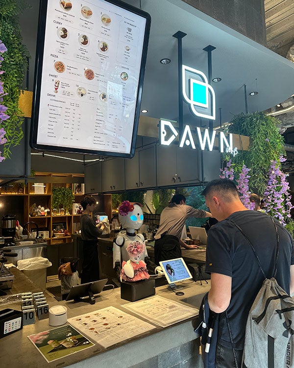 A robot barista at a cafe ordering counter