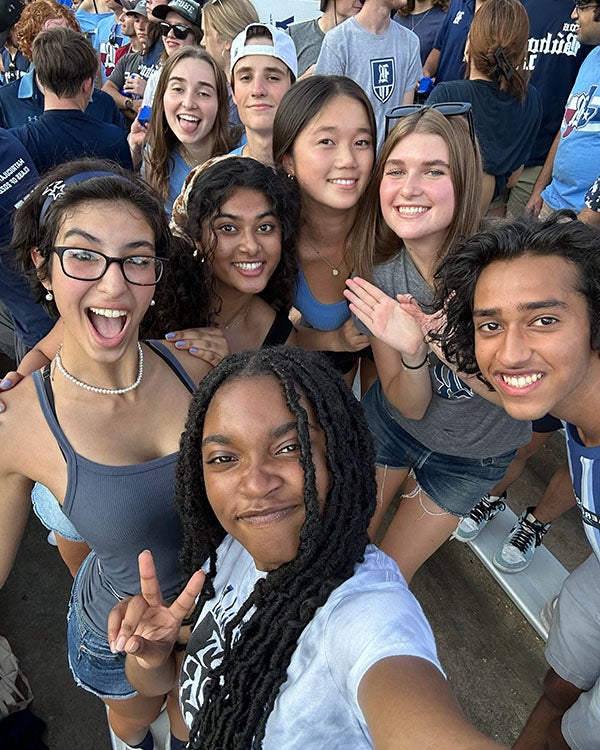 A arial-view selfie of several young adults in a crowded space