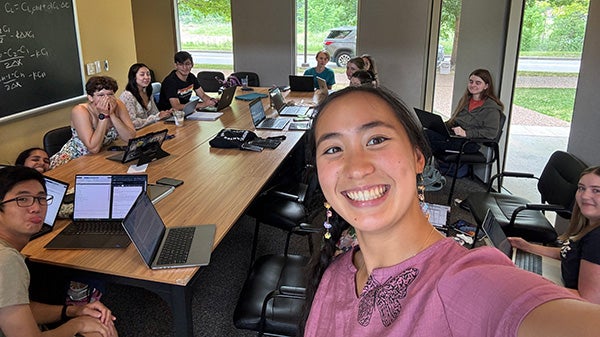 Girl taking selfie of students in a study room