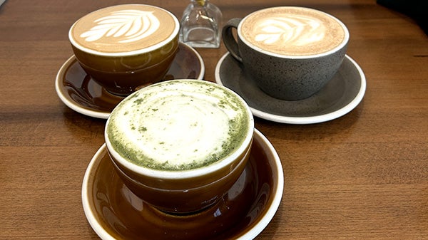 Three mugs of coffee with foam art
