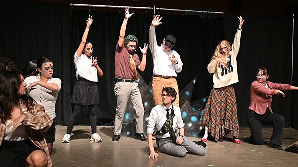 People performing in theatre on stage