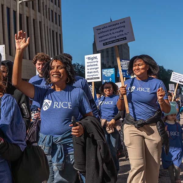People walking with signs held in the air