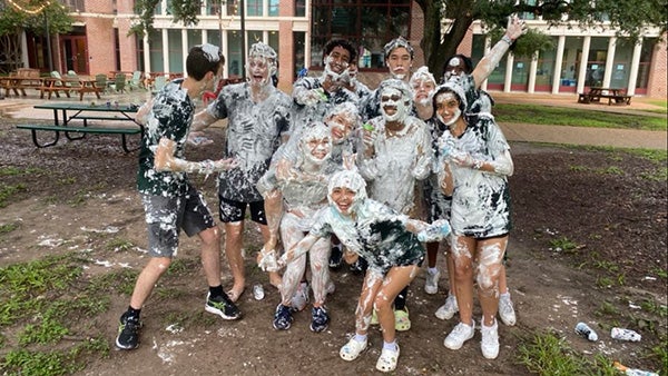 Group of people, all covered in shaving cream