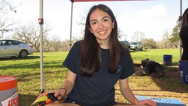 Girl smiling at camera under tent outdoors