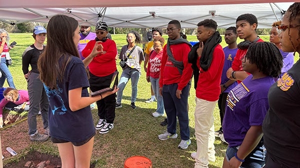 Girl speaking to large group of people