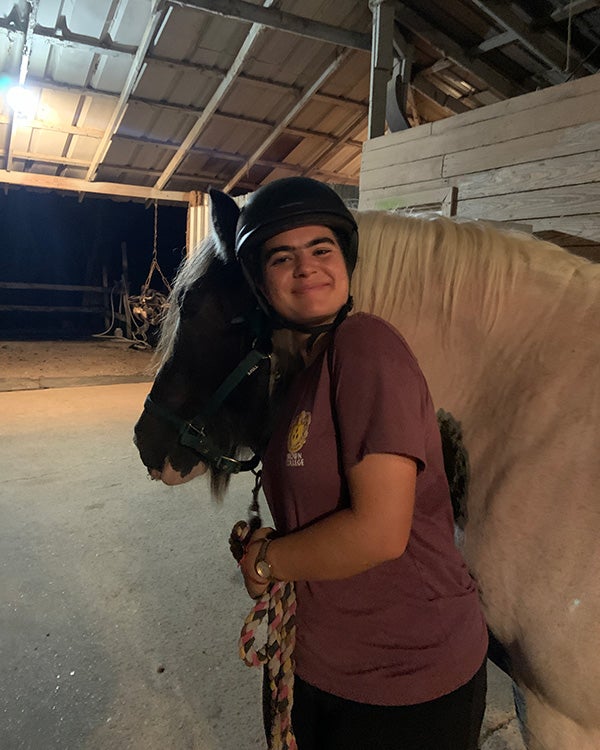 Girl hugging horse