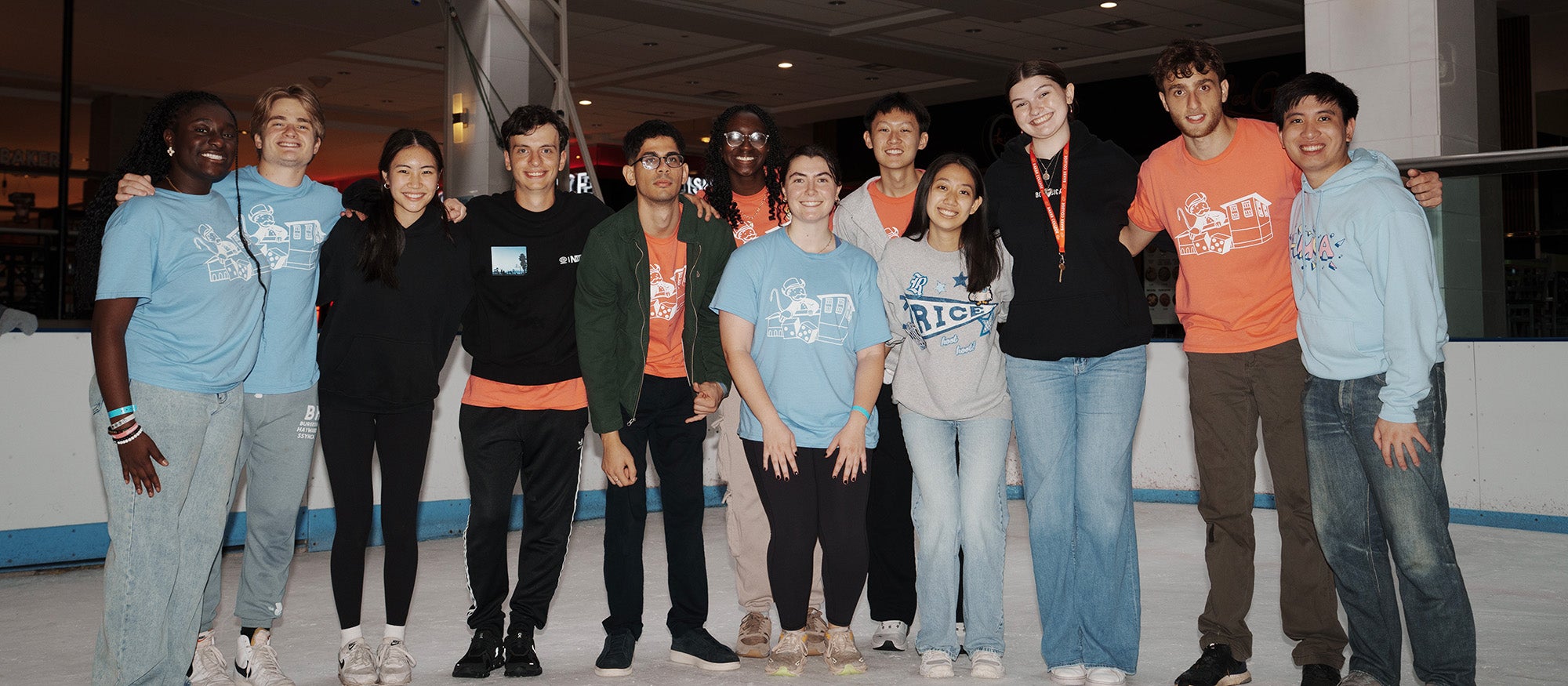 People in matching spirit shirts standing on ice rink