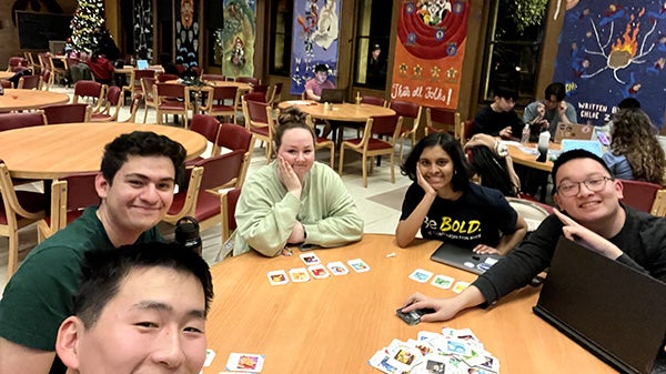 Selfie of people sitting around a table with cards on it
