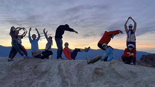 People arranging their bodies to spell out "RUGS!"