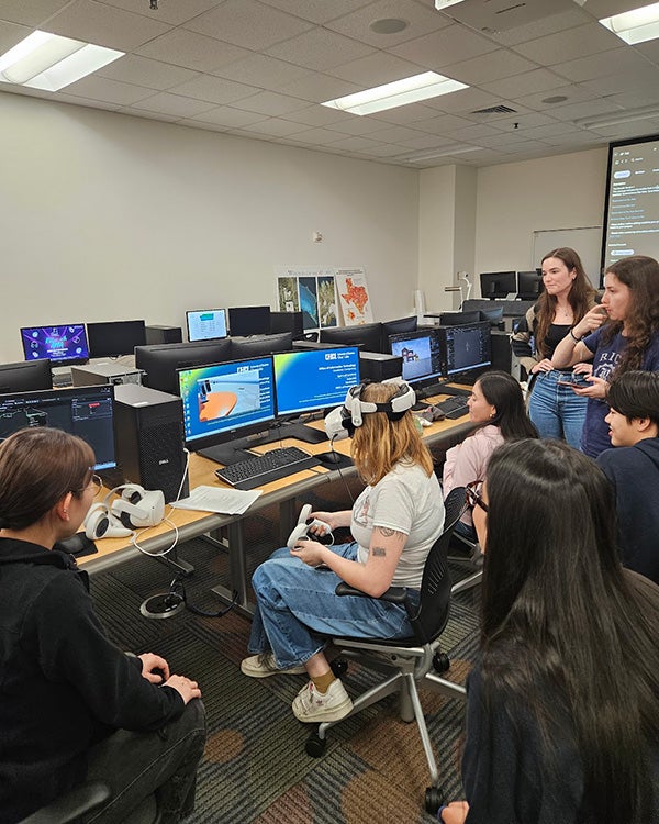 People sitting in front of computers in lab