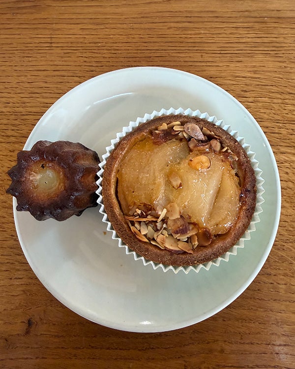 Arial view of two pastries, one large and one small, on a white plate