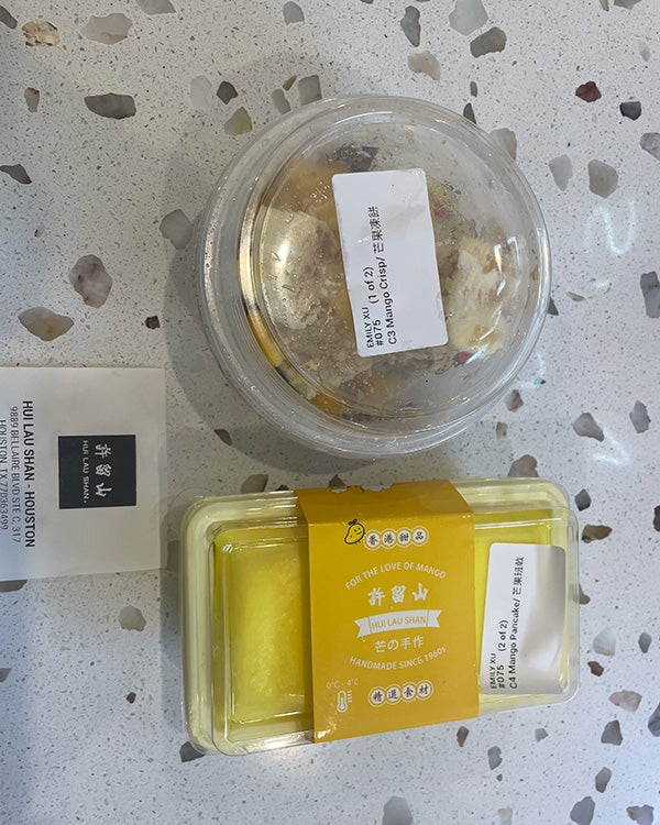 Two to-go containers of food with the label "Hui Lao Shan" 